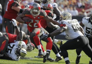 Dec 28, 2014; Tampa, FL, USA; Tampa Bay Buccaneers running back Doug Martin (22) stiff arms New Orleans Saints outside linebacker Parys Haralson (98) as he runs with the ball during the second quarter at Raymond James Stadium. Mandatory Credit: Kim Klement-USA TODAY Sports - RTR4JG7C